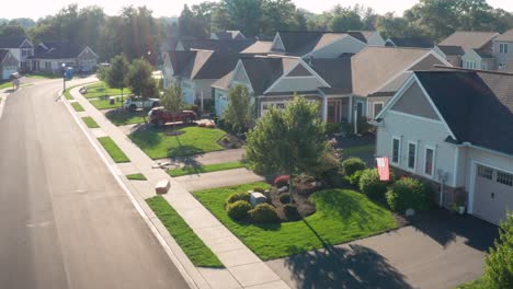 Aerial-view-of-drone-delivering-a-box,-package-to-home-in-USA