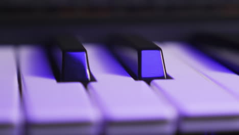 Close-up-of-two-black-keys-on-a-synthesizer-keyboard,-moving