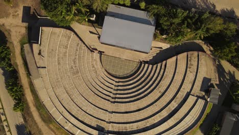 Aerial-top-view-of-empty-old-historic-Amphitheater-during-sunlight-in-Argentina---Circle-shot