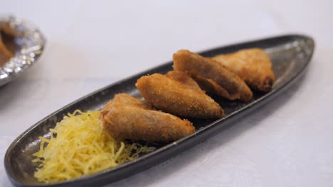 Unique-Shape-Of-Spanish-Croquetas-Served-With-Grated-Cheese-On-The-Side