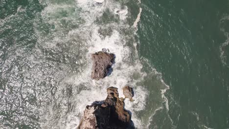 Cinematic-aerial-top-down-view-reveal-shot-capturing-Saint-Michael-the-Archangel-fort-and-Nazare-lighthouse