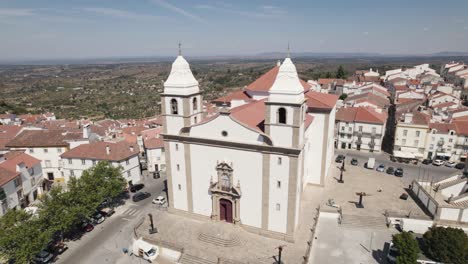 Aerial-orbit-over-mother-church-of-Castelo-de-Vide-and-Dom-Pedro-V-square---Portugal