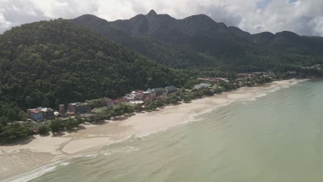 aerial-orbit-shot-of-Tropical-island-village-with-jungle,-mountains,-beach-and-tourist-resorts-on-Koh-Chang