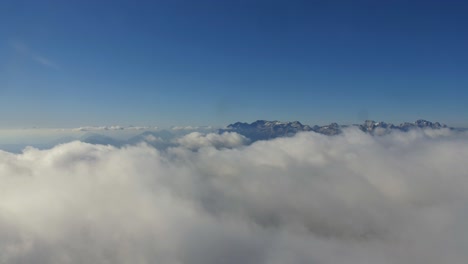 Nubes-Blancas-Esponjosas-Rodando-Por-Encima-De-Las-Montañas-En-Los-Alpes-Julianos,-Lapso-De-Tiempo-Por-Encima-De-Las-Nubes