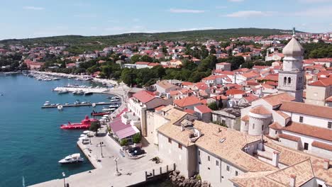 Krk-Village-at-Krk-Island,-Croatia---Aerial-Drone-View-of-the-Church,-Cathedral,-City-Walls,-Port,-Boats-and-Boulevard-at-the-Adriatic-Sea