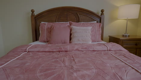 Low-angle-shot-tracking-along-bed-duvet-towards-pillows
