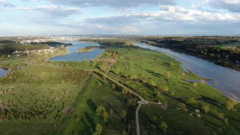Green-and-vibrant-landscape-with-Nemunas-river-and-Kaunas-city-in-horizon,-aerial-drone-view