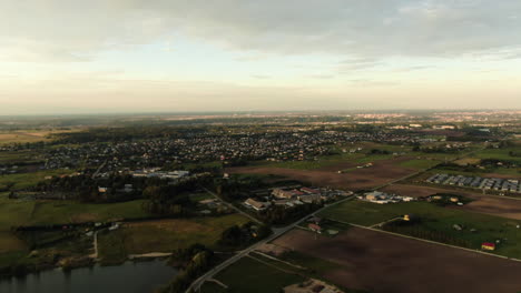 Ringaudai,-suburbs-of-Kaunas-city-on-endless-flatlands,-aerial-panning-left-view