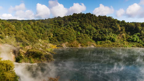 Wide-shot-of-Frying-Pan-Lake-with-toxic-sulfur-steam-during-sunny-day-in-New-Zealand