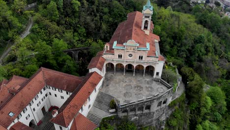 Aerial-view-of-the-historical-Madonna-del-Sasso-church-up-above-the-city-of-Locarno-next-to-Lago-Maggiore-in-Ticino-in-south-Switzerland