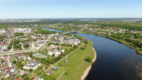 Beautiful-bridge-of-Panemune-over-river-Nemumas-with-Kaunas-city-in-horizon,-aerial-drone-view