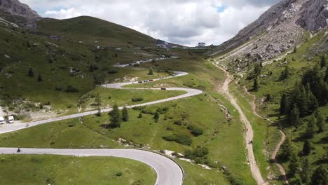 Pordoi-Mountain-Pass-at-Trentino,-South-Tyrol,-Dolomites,-Italy---Aerial-Drone-View-of-Cars-Driving-the-Hairpin-Curves-to-the-Top-of-the-Mountain