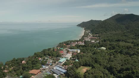 aerial-right-to-left-pan-of-tropical-island-village-with-jungle-beach-and-tourism-village-on-Koh-Chang