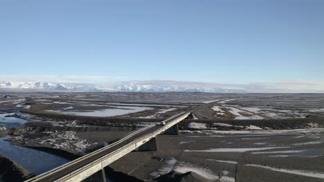 Aerial-View-Of-One-Lane-Bridge-Over-The-Nupsvotn-Glacial-River-On-A-Sunny-Day