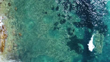 Aerial-top-down-view-of-crystal-clear-sea-water