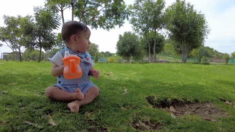 Latin-baby-boy-sitting-on-the-grass-at-the-park-in-Puebla-Mexico