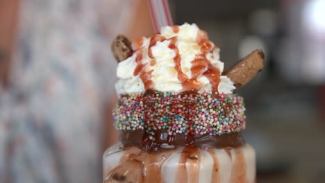 Frappe-Drink---Sprinkles-And-Cream-At-The-Top-Of-Chocolate-Monster-Shake,-close-up