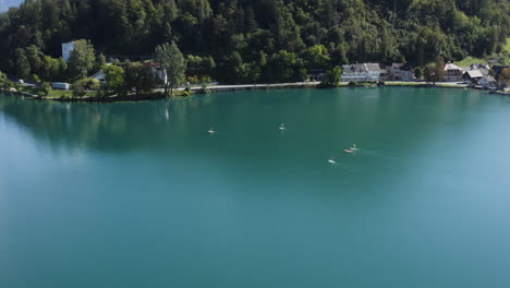 Stand-Up-Paddle-Boarding-On-Lake-Bled-In-Slovenia---aerial-shot