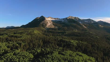 Lush-Green-Mountain-Hills-Covered-In-Pine-Trees-With-East-Beckwith-Mountain-Peak-In-Background