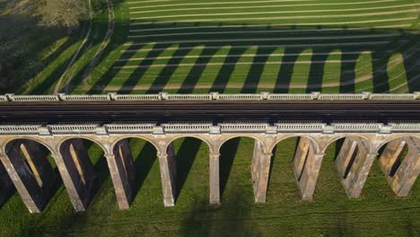 Aerial-sideways-over-railroad-of-Ouse-Valley-or-Balcombe-viaduct,-Sussex-in-England,-UK