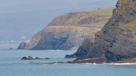 Inclined-rock-strata-in-cliffs-near-Aberystwyth,-Ceredigion-in-West-Wales-on-the-Irish-Sea-coast