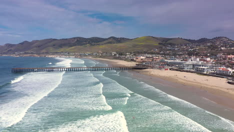 The-resort-town-of-Pismo-Beach-and-the-landmark-pier-and-landscape---parallax-aerial-view