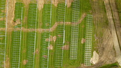photovoltaic-farm-construction-site,-green-field-prepared-for-solar-power-plant-construction---aerial-top-down