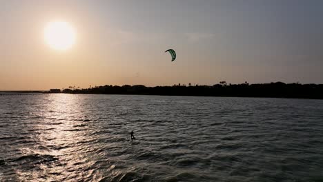 Lone-Kitesurfer-at-Violet-Andrews-park-area-in-Portland,-Texas-at-sunset