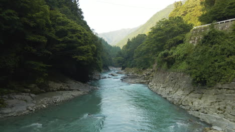 Blue-Green-River-Flowing-Through-Mountains-On-The-Island-Of-Shikoku,-Japan