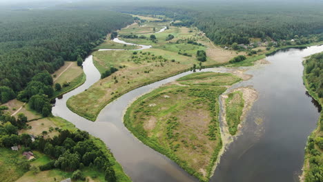 Nemunas-and-Merkys-river-confluence-surrounded-by-dense-forestry-landscape,-aerial-drone-view