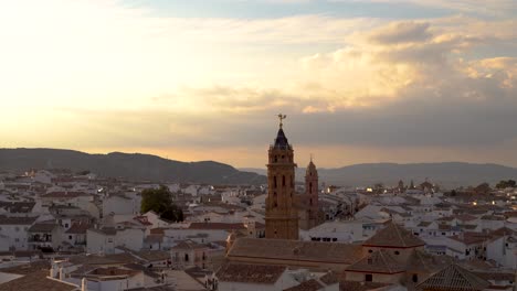 Panoramic-view-high-above-typical-Spanish-city-with-church-at-sunset
