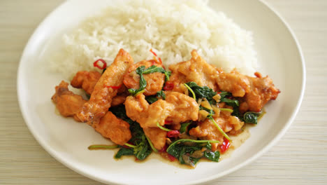 stir-fried-fried-fish-with-basil-and-chili-in-thai-style-topped-on-rice---Asian-food-style