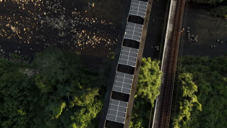 Top-Down-Aerial-Shot-Of-Solar-Panels-On-An-Abandoned-Monorail-Track-In-Japan