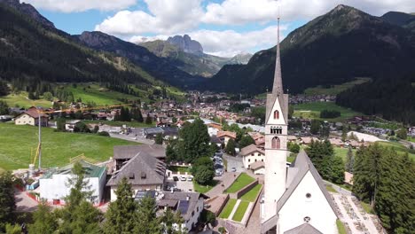 Vigo-di-Fassa-at-Fassa-Valley-,-Trentino,-Dolomites,-Italy---Aerial-Drone-View-of-the-Picturesque-Mountain-Village