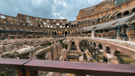 Dolly-forward-showing-spectacular-old-ruin-walls-inside-Colosseum-of-Rome-in-Italy