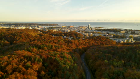 Beautiful-autumn-forest-colors-in-Gdynia-Poland-coastal-city-scenic-aerial-dolly-shot