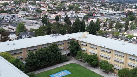Aerial-over-Crenshaw-high-school,-main-building-of-campus,-empty-on-the-weekend