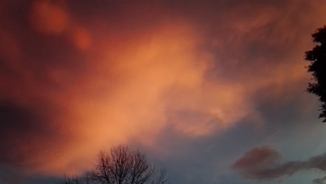 Pan-across-orange-and-red-storm-clouds-at-sunset