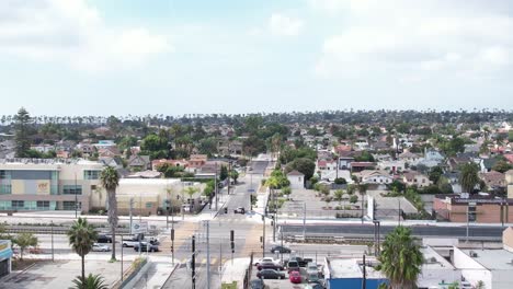 Crenshaw-neighbourhood-suburban-homes-palm-tree-streets-aerial-rising-view