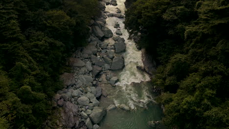 Aerial-Tilting-Up-From-River-In-Rural-Japan-On-the-Island-Of-Shikoku-In-The-Tokushima-Prefecture