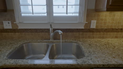 Clean-kitchen-sink-tap-running-water-gimbal-shot