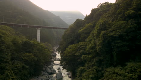 Aerial-Tilting-Down-Over-River-In-Rural-Japan-On-the-Island-Of-Shikoku-In-The-Tokushima-Prefecture