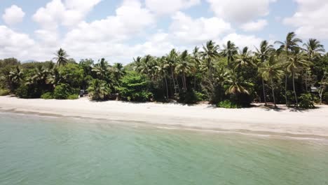 Paralaje-De-Drones-Sobre-Aguas-Azules-Tropicales-Con-Palmeras-Y-Playa