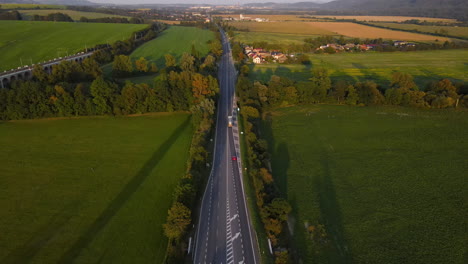 Aerial-view-of-a-multi-way-road-with-an-intersection-and-passing-cars