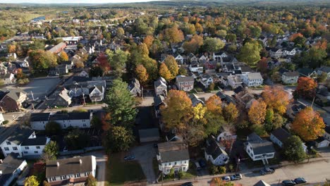 Drone-Aerial-View,-Concord,-New-Hampshire-USA-Flying-Above-Houses-in-Residential-Neighborhood,-Colorful-Tree-Foliage-on-Sunny-Autumn-Day