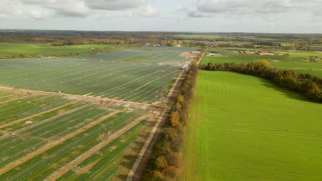 Construction-Site-Of-The-Largest-in-Poland-Solar-Energy-Park-Near-Zwartowo,-Poland-in-Autumn---Aerial-Wide-Shot