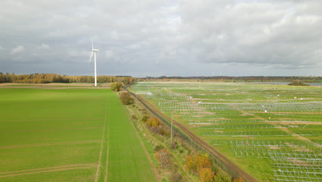 Green-Electricity-production---Wind-Turbine-and-Building-Site-Of-The-Largest-Photovoltaic-Solar-Cells-Near-Zwartowo-Pomerania,-Poland