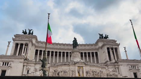 Tilt-down-shot-of-italian-Altar-of-the-Fatherland-with-flag-against-cloudy-sky-in-Rome,Italy