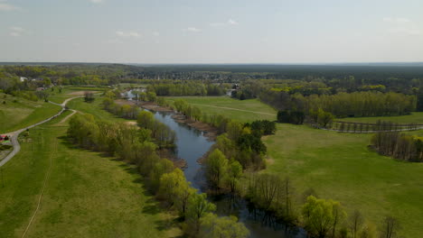 Aerial-view-of-Myslecinek-City-park-with-path-to-walk-around-lake-in-Bydgoszcz,Poland