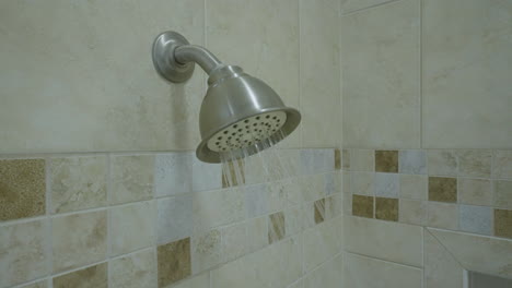 Close-up-flowing-shower-head-interior-bathroom-4k